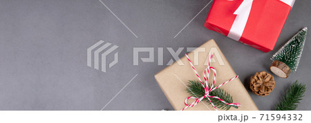 Christmas holiday composition with red gift box decoration on cement floor background. 71594332