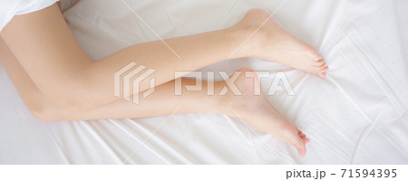 Beautiful leg of woman slim sexy on bed at bedroom, skin smooth of beauty girl feet health care. 71594395