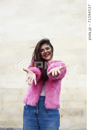 young cute girl teenager in pink fur coat gesturing hanging around outdoor , lifestyle people concept young cute girl teenager in pink fur coat gesturing hanging around outdoor , lifestyle people concept 71594537