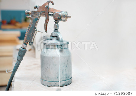 spray gun close-up. tool for industrial painting of materials and iron. 71595007