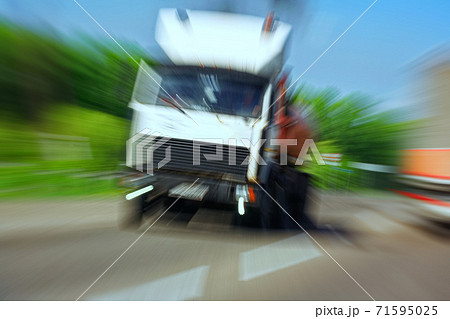 Truck in a blur on the road in motion. The danger of a collision or emergency situation. Violation of rules by truckers Truck in a blur on the road in motion. The danger of a collision or emergency situation. Violation of rules by truckers 71595025