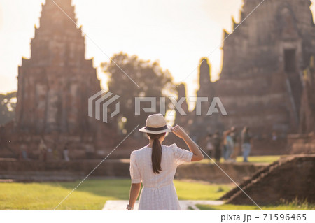 Tourist Woman in white dress visiting to ancient stupa in Wat Chaiwatthanaram temple in Ayutthaya Historical Park, summer, Asia and Thailand travel concept Tourist Woman in white dress visiting to ancient stupa in Wat Chaiwatthanaram temple in Ayutthaya Historical Park, summer, Asia and Thailand travel concept 71596465