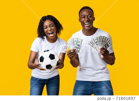 Excited african-american couple enjoying sport bet win 71601697