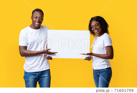 Happy black lovers holding blank board for text 71601709