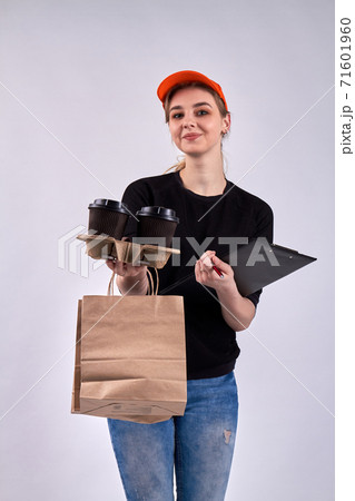Smiling courier girl is holding coffee. 71601960