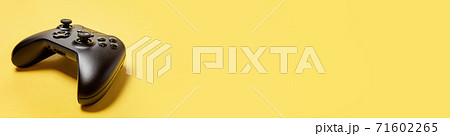 Black joystick gamepad game console isolated on yellow colourful trendy background. Computer gaming competition videogame control confrontation concept. Cyberspace symbol Banner 71602265
