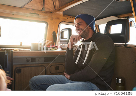 Traveler man sitting at the car Traveler man sitting at the car 71604109