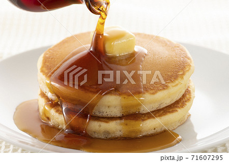 積み重ねたホットケーキにメープルシロップをかけて食べる 71607295