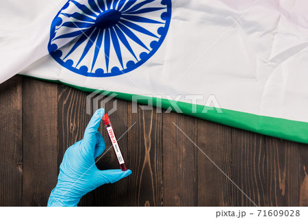 Hands of a doctor wearing gloves holding blood test tube coronavirus Hands of a doctor wearing gloves holding blood test tube coronavirus 71609028