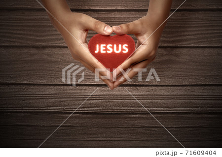 Human hands showing red heart with Jesus text Human hands showing red heart with Jesus text 71609404