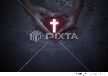 Human hands showing red heart with Christian cross Human hands showing red heart with Christian cross 71609405