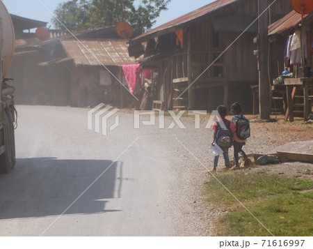 Laos school children and people riding on main road street to school and work in VANG VIENG provinces of LAOS. Laos school children and people riding on main road street to school and work in VANG VIENG provinces of LAOS. 71616997