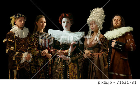 Medieval people as a royalty persons in vintage clothing on dark background. Concept of comparison of eras, modernity and renaissance. Creative collage. 71621731