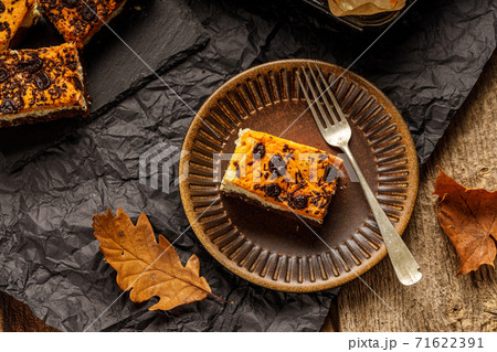 Delicious pumpkin cake with cheese cream and cacao or chocolate on the top Delicious pumpkin cake with cheese cream and cacao or chocolate on the top 71622391