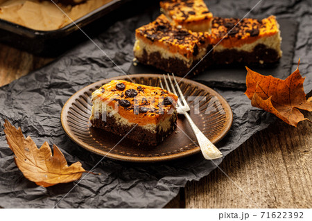 Delicious pumpkin cake with cheese cream and cacao or chocolate on the top Delicious pumpkin cake with cheese cream and cacao or chocolate on the top 71622392