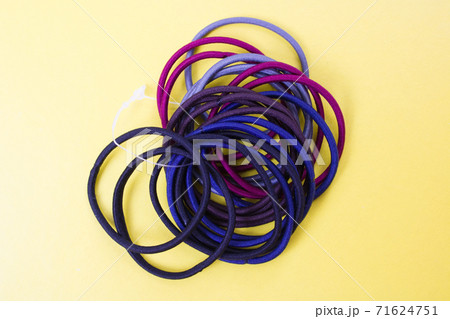 Pile of hair ties on yellow background Pile of hair ties on yellow background 71624751