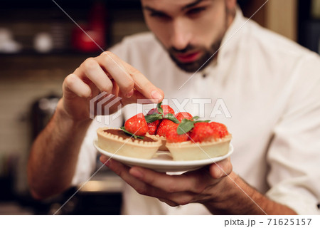 Young Bearded Man with Cake Standing in Bakery. 71625157