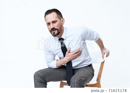 The man bent down and feels pain in his heart. 71625178