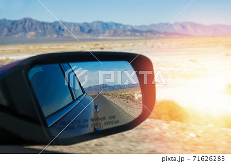Car's side mirror close-up with blurred desert and mountains Car's side mirror close-up with blurred desert and mountains 71626283