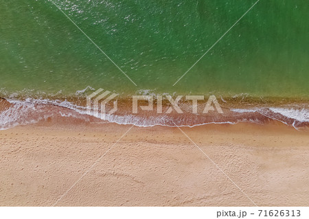 Aerial top view of the beach with sand and small waves Aerial top view of the beach with sand and small waves 71626313