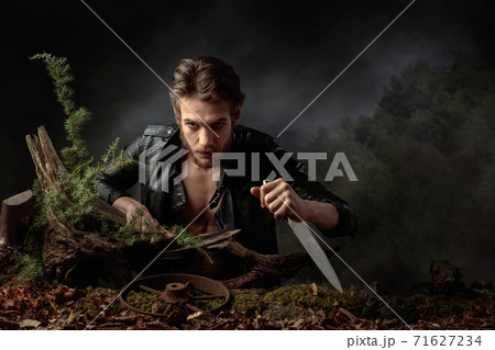 Portrait of a young man with a knife. Portrait of a young man with a knife. 71627234