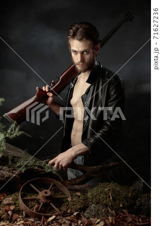 Portrait of a young man with a rifle. Portrait of a young man with a rifle. 71627236