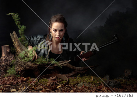 Portrait of a young woman with a rifle. Portrait of a young woman with a rifle. 71627262