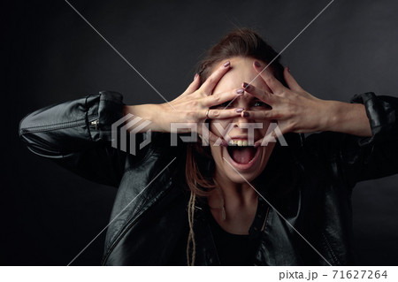Screaming woman covers her face with her hands. Screaming woman covers her face with her hands. 71627264