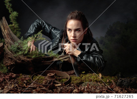 Portrait of a young woman with a knife. 71627265