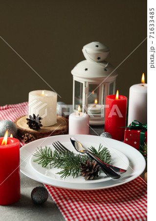 Concept of New year table setting with candles on gray table 71633485