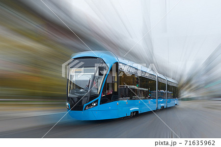 Blue electric tram on blurred background. Blue electric tram on blurred background. 71635962