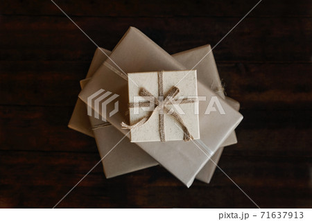 Top view stack of many xmas gift boxes wrapped in recycled kraft paper. Eco-Friendly, Sustainable, zero waste, natural color Christmas gift boxes 71637913