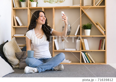 Cute happy woman holding cellphone, using mobile dating application to chat or sending message. Cute happy woman holding cellphone, using mobile dating application to chat or sending message. 71639812