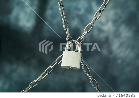 Locked padlock on metal chains Locked padlock on metal chains 71640535