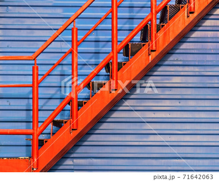 part of red fire escape on the blue wall 71642063