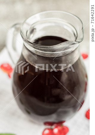 jar with cherry brandy liqueur a wine 71642291
