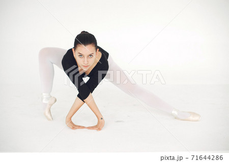 Ballerina posing in front of white background 71644286