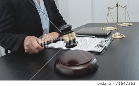 Judge or a lawyer works documents in the courtroom and analyze the various laws for justice and accuracy, Litigation and justice concept. Judge or a lawyer works documents in the courtroom and analyze the various laws for justice and accuracy, Litigation and justice concept. 71647263