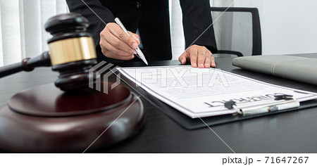 Judge or a lawyer works documents in the courtroom and analyze the various laws for justice and accuracy, Litigation and justice concept. Judge or a lawyer works documents in the courtroom and analyze the various laws for justice and accuracy, Litigation and justice concept. 71647267
