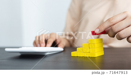 Arrange the wooden blocks into steps, higher the marketing strategy the more effort is required, Driving business at the peak concept. 71647913