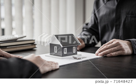 Real estate agent or sales manager has proposed terms and conditions to customers who sign house purchase agreements with insurance, Agreement to sign the purchase contract concept. Real estate agent or sales manager has proposed terms and conditions to customers who sign house purchase agreements with insurance, Agreement to sign the purchase contract concept. 71648427