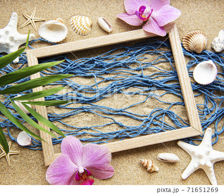 Blue Fishing net and wooden frame on a beach sand, travel concept Blue Fishing net and wooden frame on a beach sand, travel concept 71651269