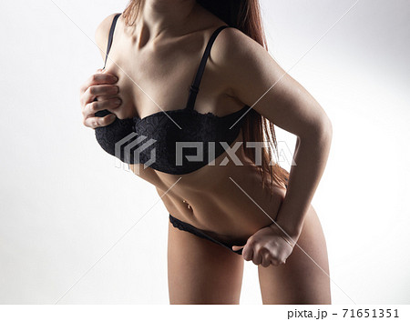 Young sexy girl in black lingerie on white background 71651351
