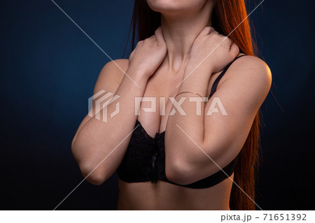 Image of young woman with hands on black bra Image of young woman with hands on black bra 71651392