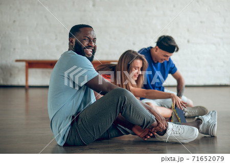 Dancers stretching their muscles before the training Dancers stretching their muscles before the training 71652079