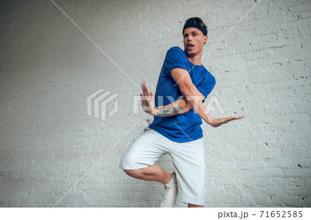 Man wearing blue t-shirt making dancing movements 71652585