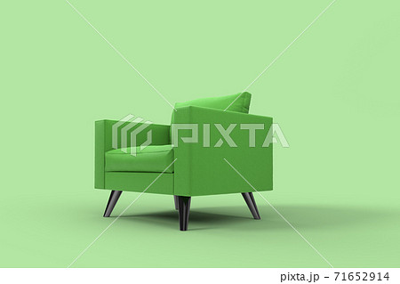 Green armchair with pillows on studio green background. 71652914
