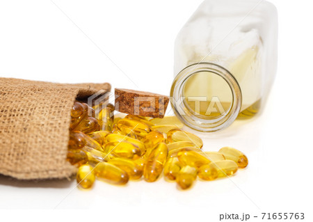 Omega 3 capsules in a bag and a bottle of fish oil Omega 3 capsules in a bag and a bottle of fish oil 71655763