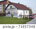 Facade thermal insulation and painting works, scaffolding in a village 71657348