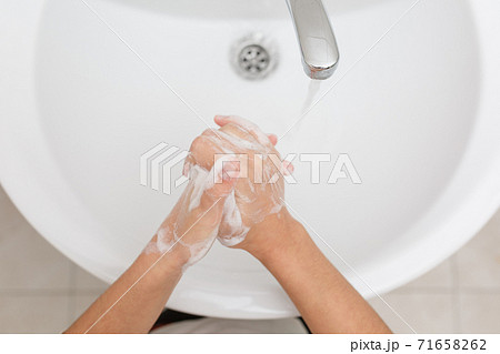 Washing hands in the bathroom. Washing hands in the bathroom. 71658262